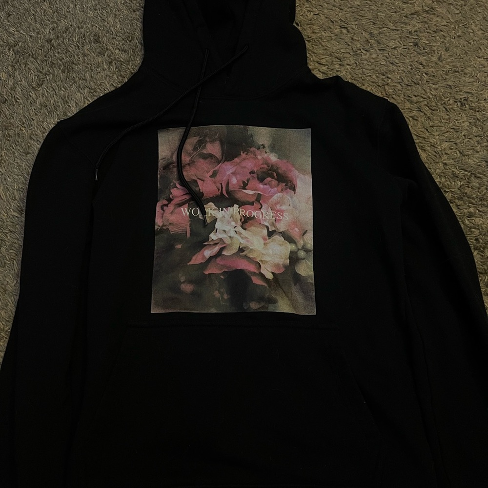 black and floral “work in progress” hoodie